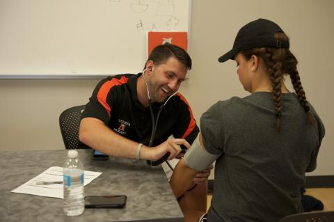 staff giving physicals